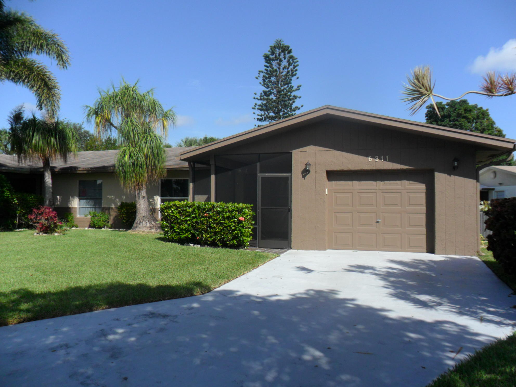 6311 Lasalle Road Delray Beach, FL 33484 - Photo 1 of 34 a front view of a house with a yard and garage