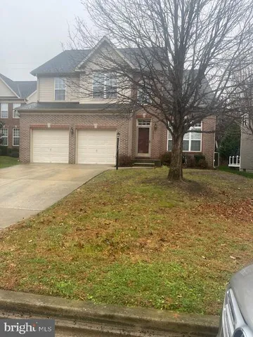a house that has a tree in front of it