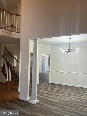 a view of a room with wooden floor