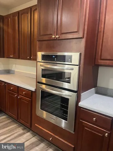 a kitchen with granite countertop wood cabinets and stainless steel appliances