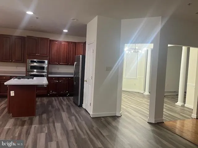 a kitchen with wooden floors and wooden cabinets