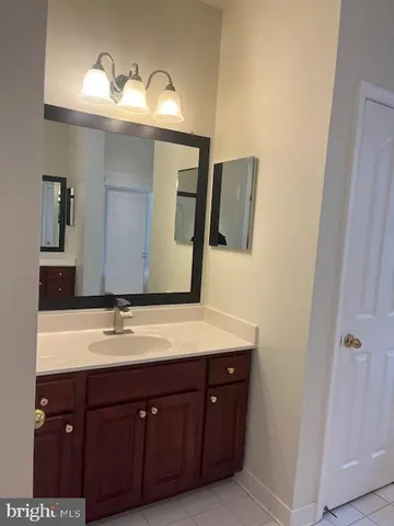 a bathroom with a double vanity sink and mirror