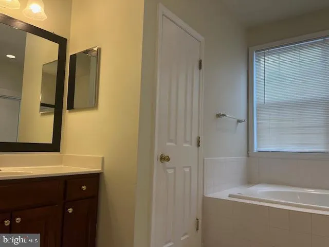a bathroom with a sink a shower and a mirror