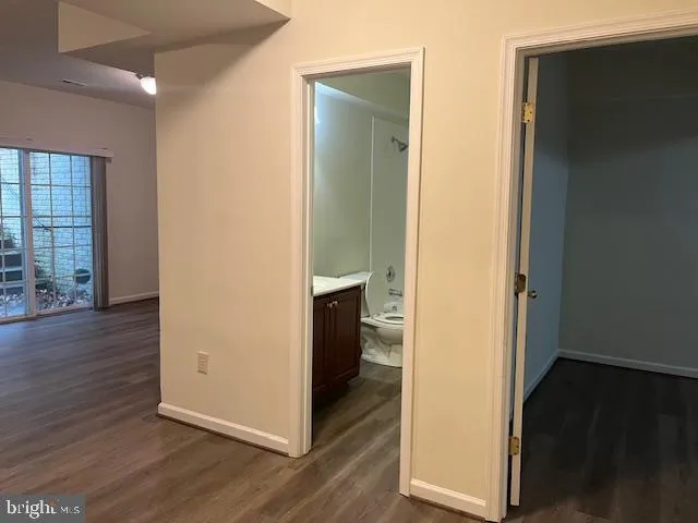 an empty room with wooden floor and closet