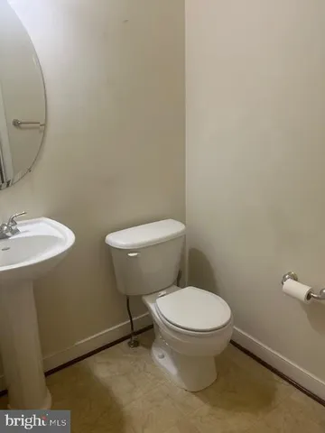 a white toilet sitting next to a bathroom sink