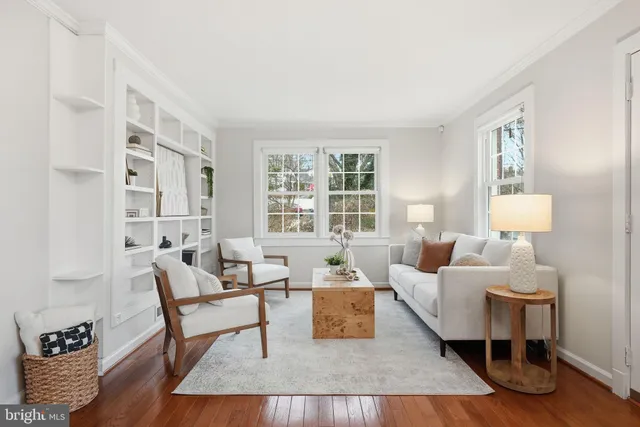 a living room with furniture wooden floor and a large window