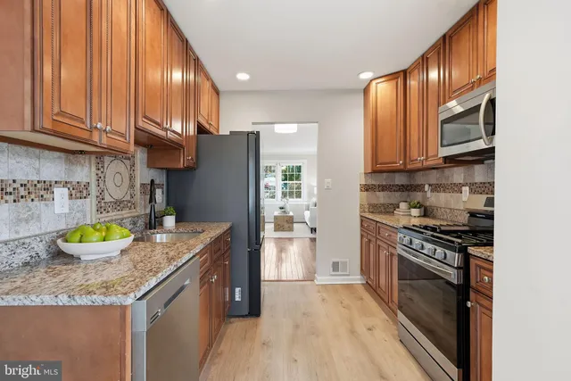 a kitchen with a sink a stove and cabinets