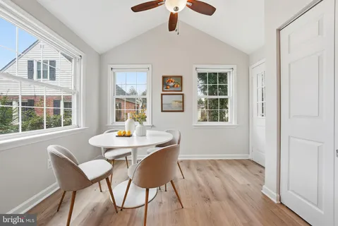 a dining room with furniture window and wooden floor