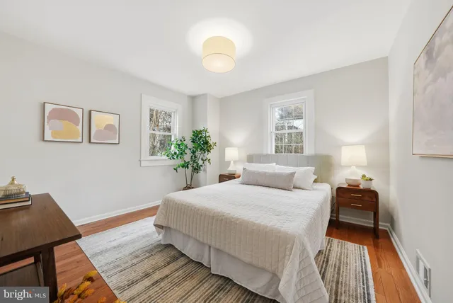 a bedroom with a bed and a potted plant
