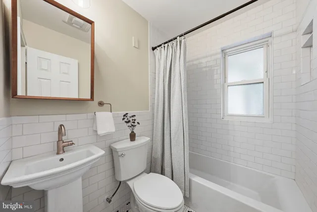 a bathroom with a toilet sink and shower