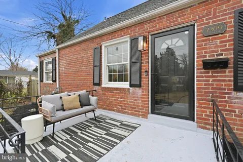 a view of a patio with couches table and chairs and potted plants