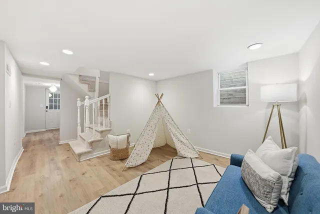 a living room with furniture and a wooden floor