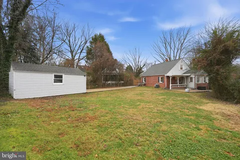 a front view of house with yard and trees