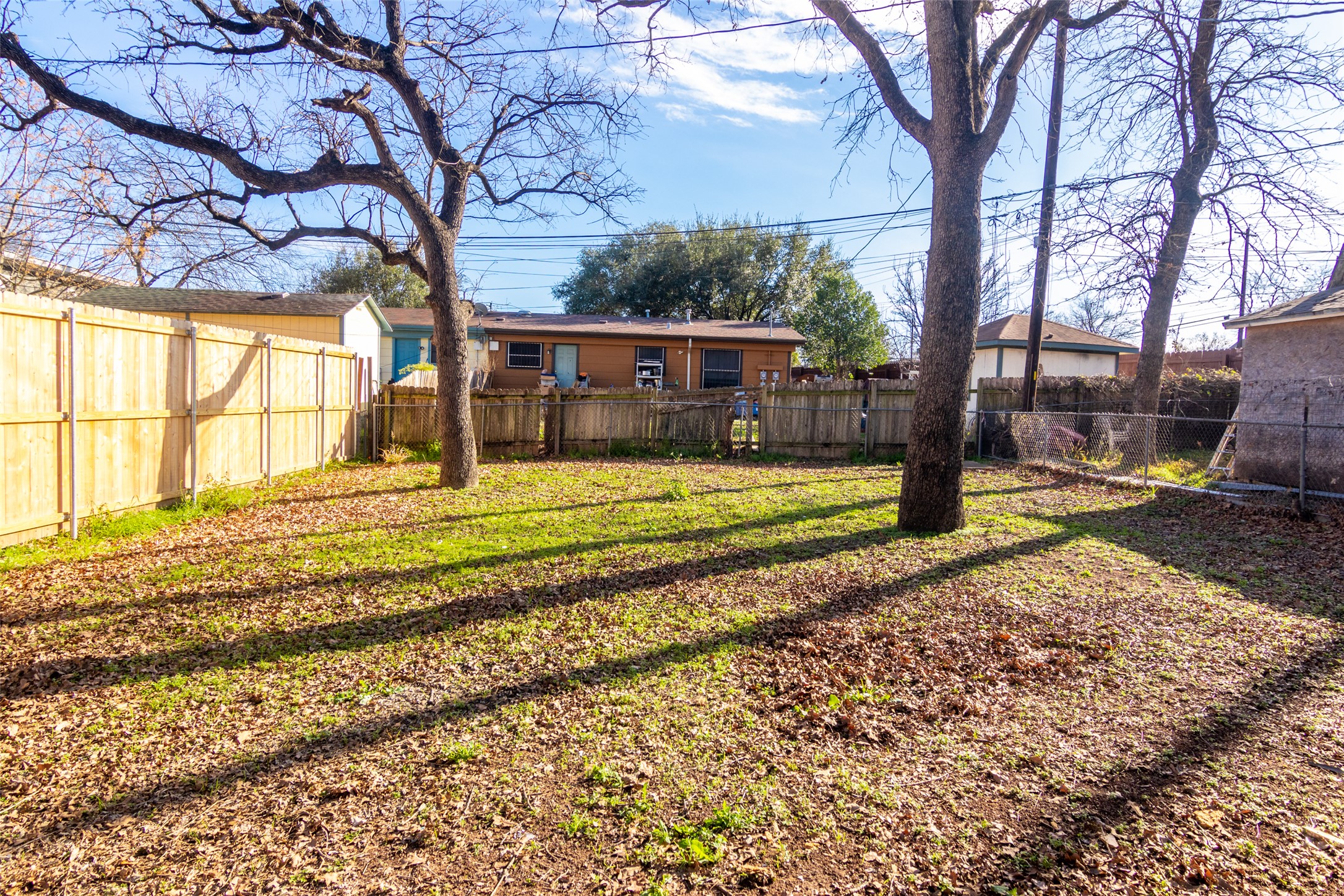 3203 East 16th Street Austin, TX 78721 - Photo 20 of 21 Mature trees and a spacious fenced yard create a great canvas for making the outdoor space your own.