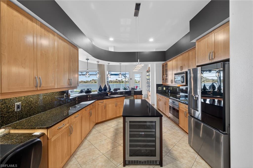 12095 Wicklow Lane Naples, FL 34120 - Photo 11 of 50 a large kitchen with stainless steel appliances kitchen island granite countertop a refrigerator a sink dishwasher a stove and a sink