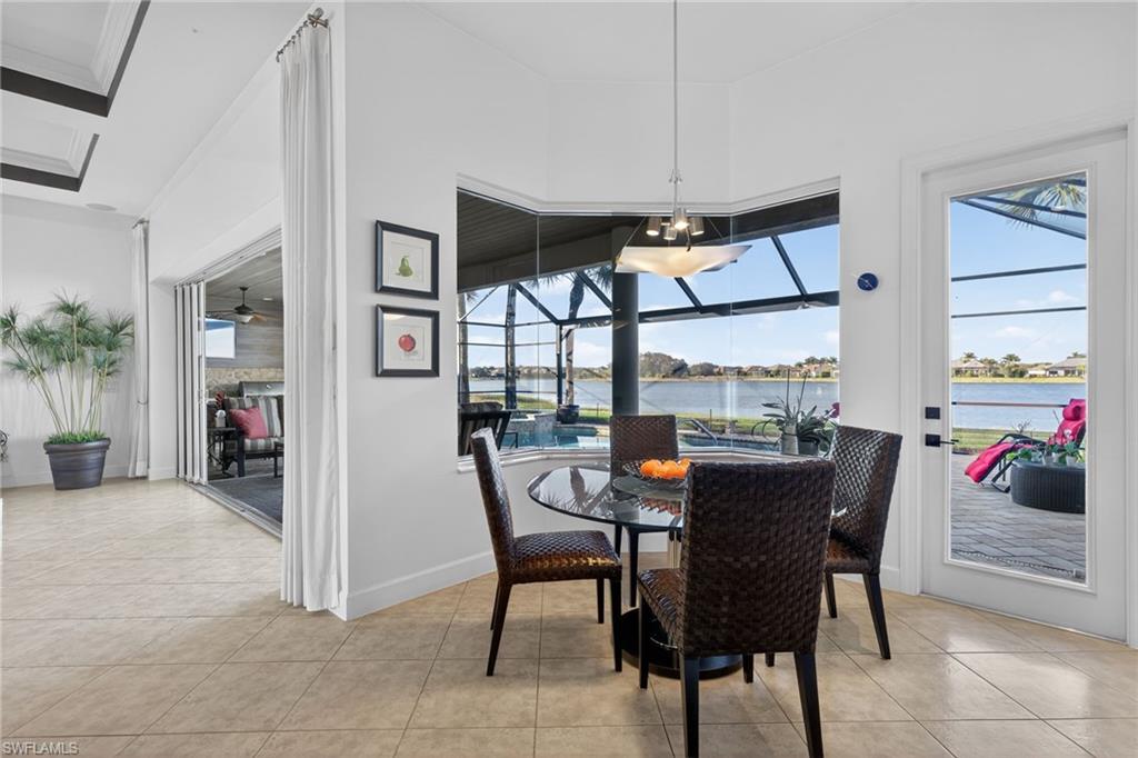 12095 Wicklow Lane Naples, FL 34120 - Photo 12 of 50 a view of a dining room with furniture window and wooden floor
