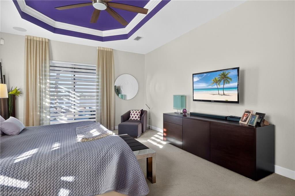 12095 Wicklow Lane Naples, FL 34120 - Photo 15 of 50 a bed room with a bed and a television