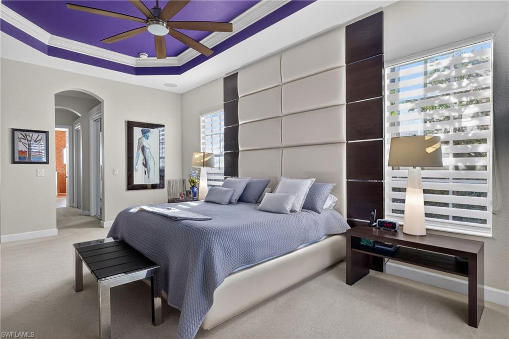 12095 Wicklow Lane Naples, FL 34120 - Photo 16 of 50 a bedroom with a bed and a chandelier