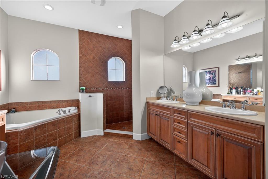 12095 Wicklow Lane Naples, FL 34120 - Photo 18 of 50 a spacious bathroom with a tub sink and mirror