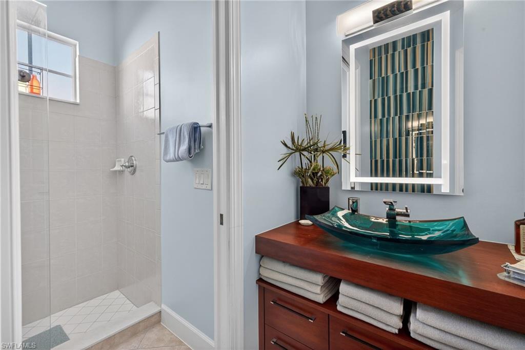 12095 Wicklow Lane Naples, FL 34120 - Photo 21 of 50 a bathroom with a sink and a mirror