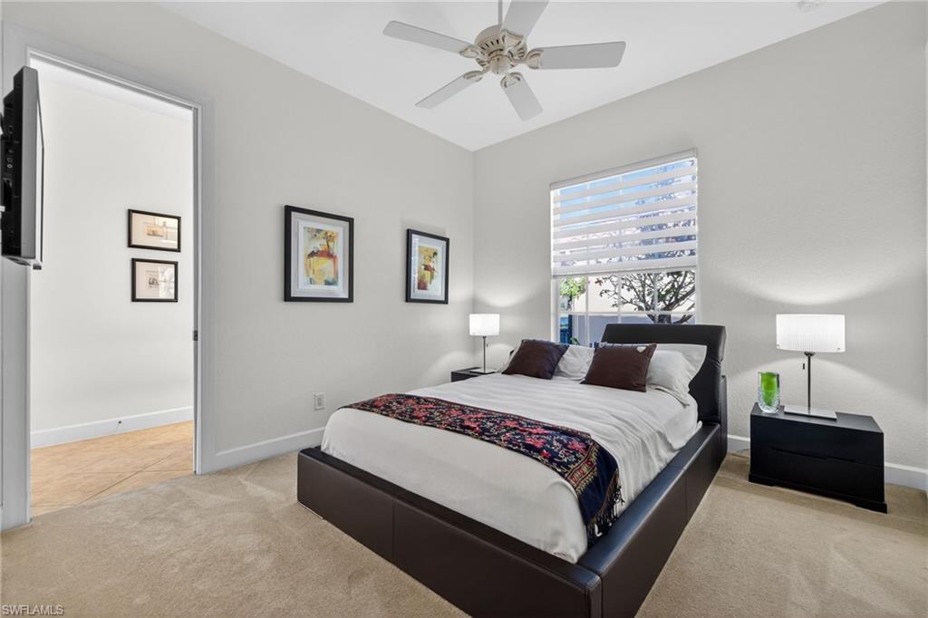 12095 Wicklow Lane Naples, FL 34120 - Photo 22 of 50 a bedroom with a bed lamp and closet