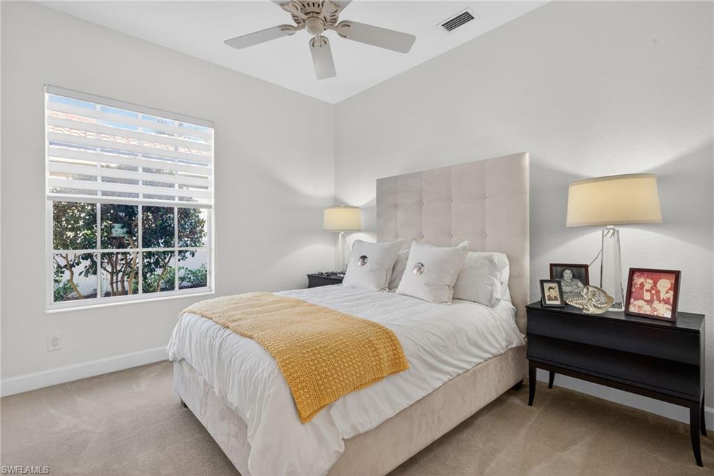 12095 Wicklow Lane Naples, FL 34120 - Photo 23 of 50 a bedroom with a bed and a window