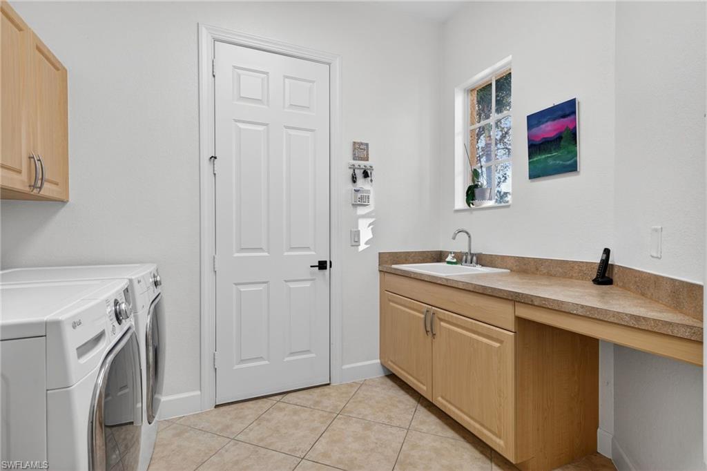 12095 Wicklow Lane Naples, FL 34120 - Photo 27 of 50 a spacious bathroom with a sink and a mirror