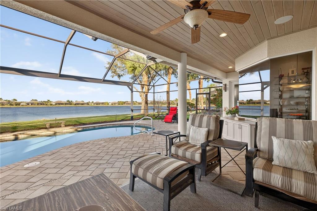 12095 Wicklow Lane Naples, FL 34120 - Photo 28 of 50 a living room with furniture and a floor to ceiling window