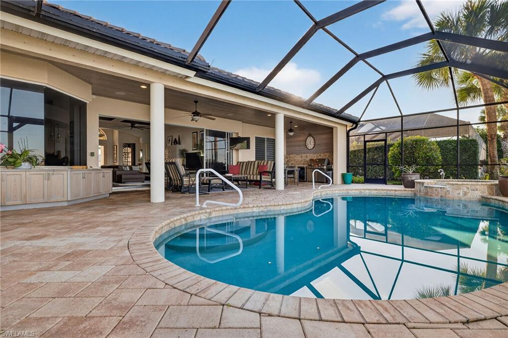 12095 Wicklow Lane Naples, FL 34120 - Photo 29 of 50 a view of a swimming pool with outdoor seating