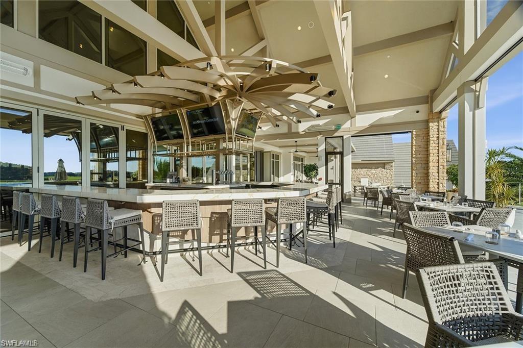 12095 Wicklow Lane Naples, FL 34120 - Photo 36 of 50 an outdoor space with lots of tables and chairs