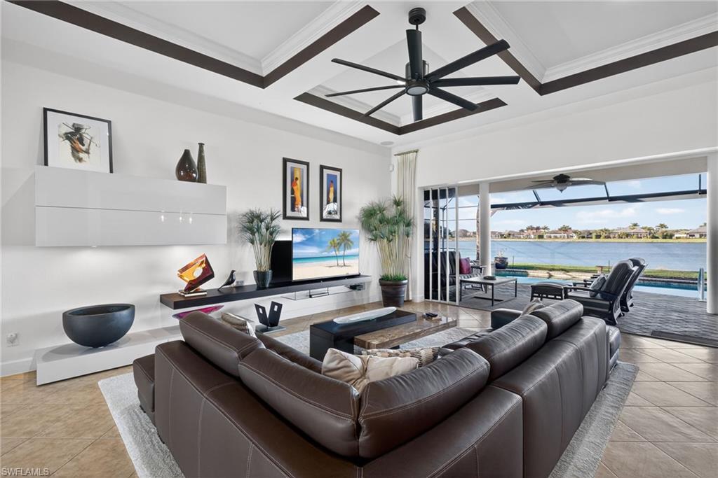 12095 Wicklow Lane Naples, FL 34120 - Photo 4 of 50 a living room with furniture a ceiling fan and a rug