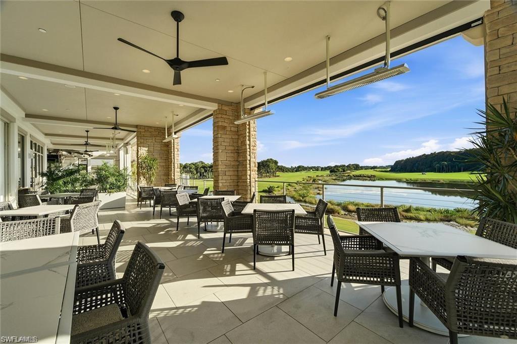 12095 Wicklow Lane Naples, FL 34120 - Photo 46 of 50 a living room with lots of furniture and a floor to ceiling window