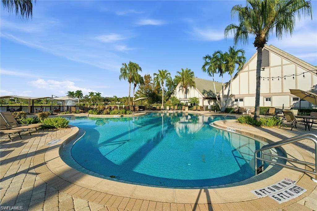12095 Wicklow Lane Naples, FL 34120 - Photo 48 of 50 a view of a swimming pool with a patio and a garden