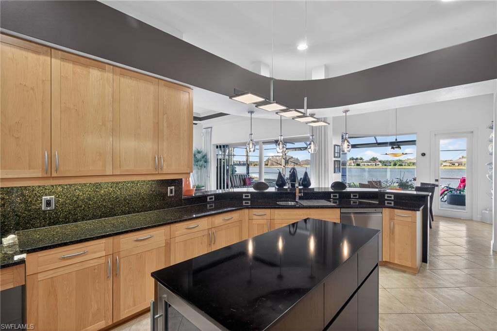 12095 Wicklow Lane Naples, FL 34120 - Photo 10 of 50 a kitchen with a sink a counter top space cabinets and stainless steel appliances