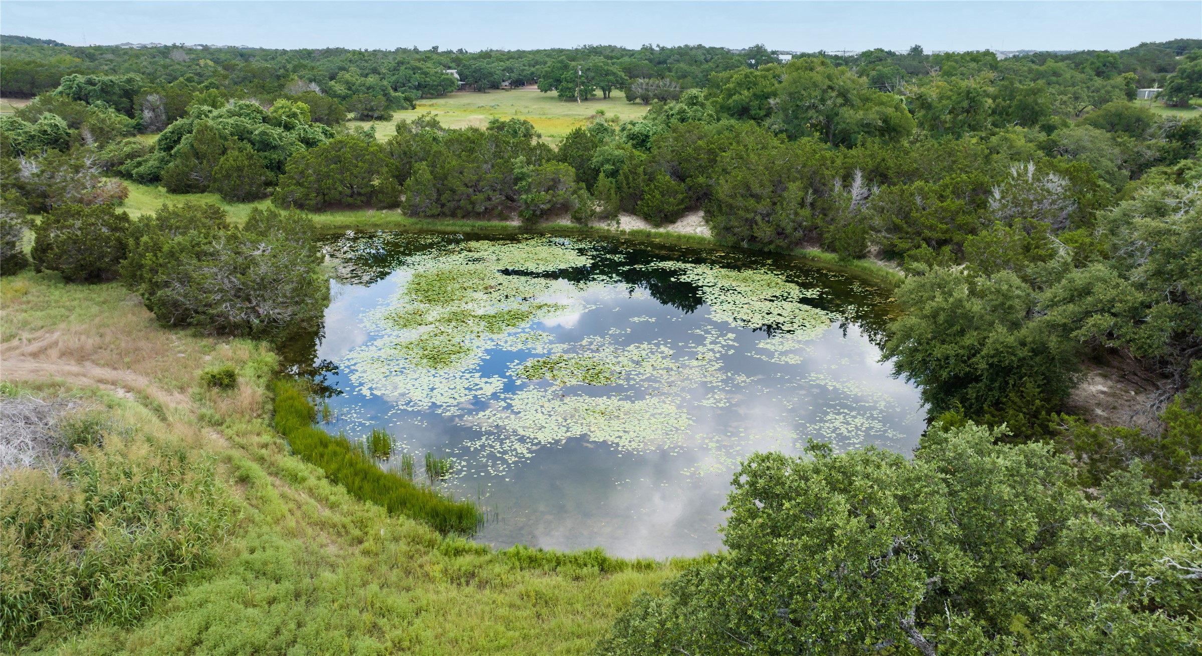 Tbd Kestrel Drive Austin, TX 78737 - Photo 7 of 8 a view of a lake with a forest