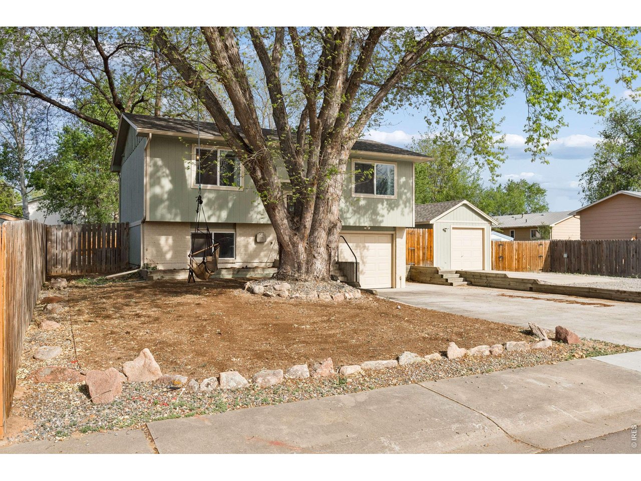 158 4th Street Firestone, CO 80520 - Photo 1 of 32 a front view of a house with a yard covered in snow