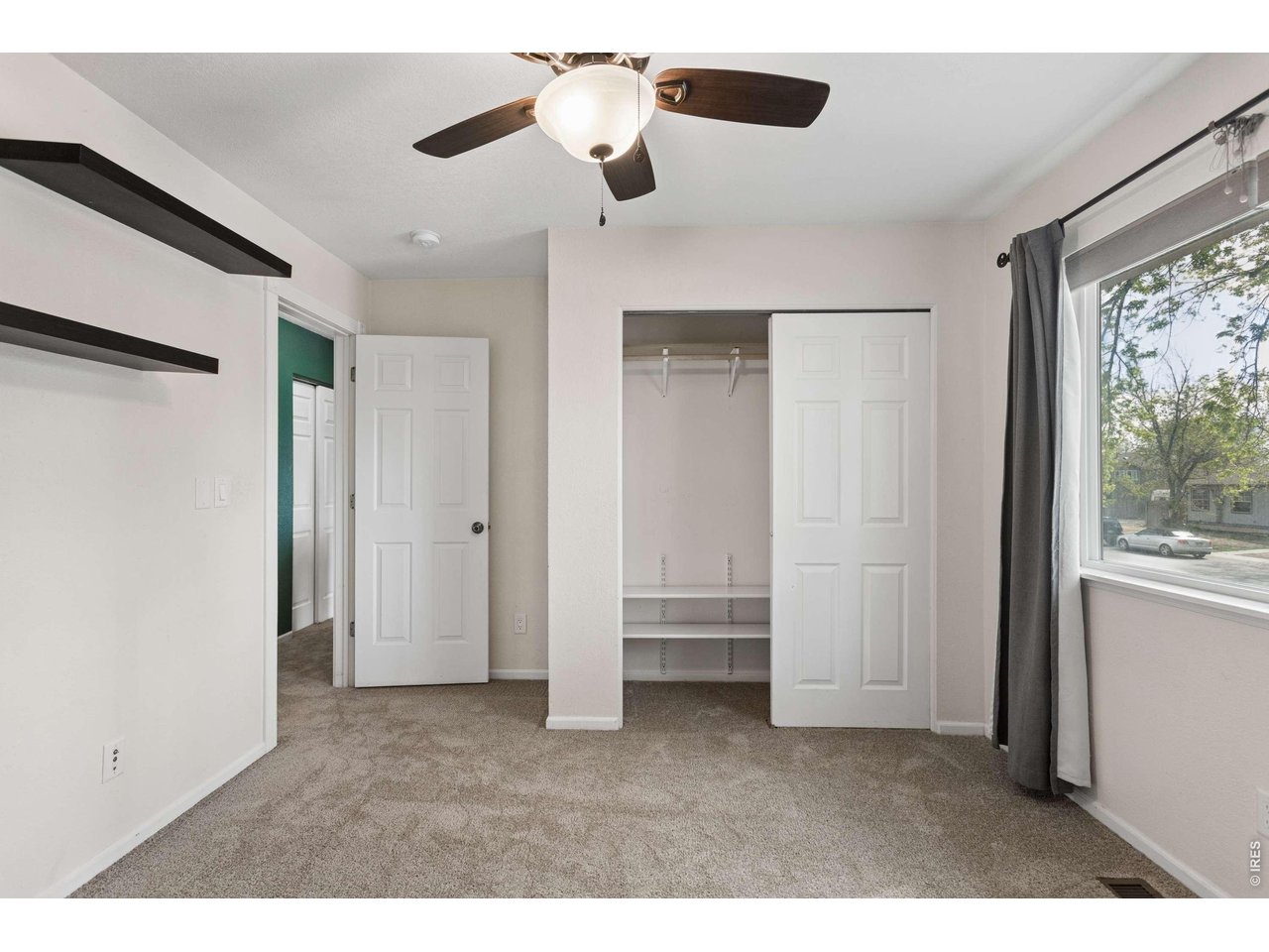 158 4th Street Firestone, CO 80520 - Photo 11 of 32 a big room with chandelier fan and windows