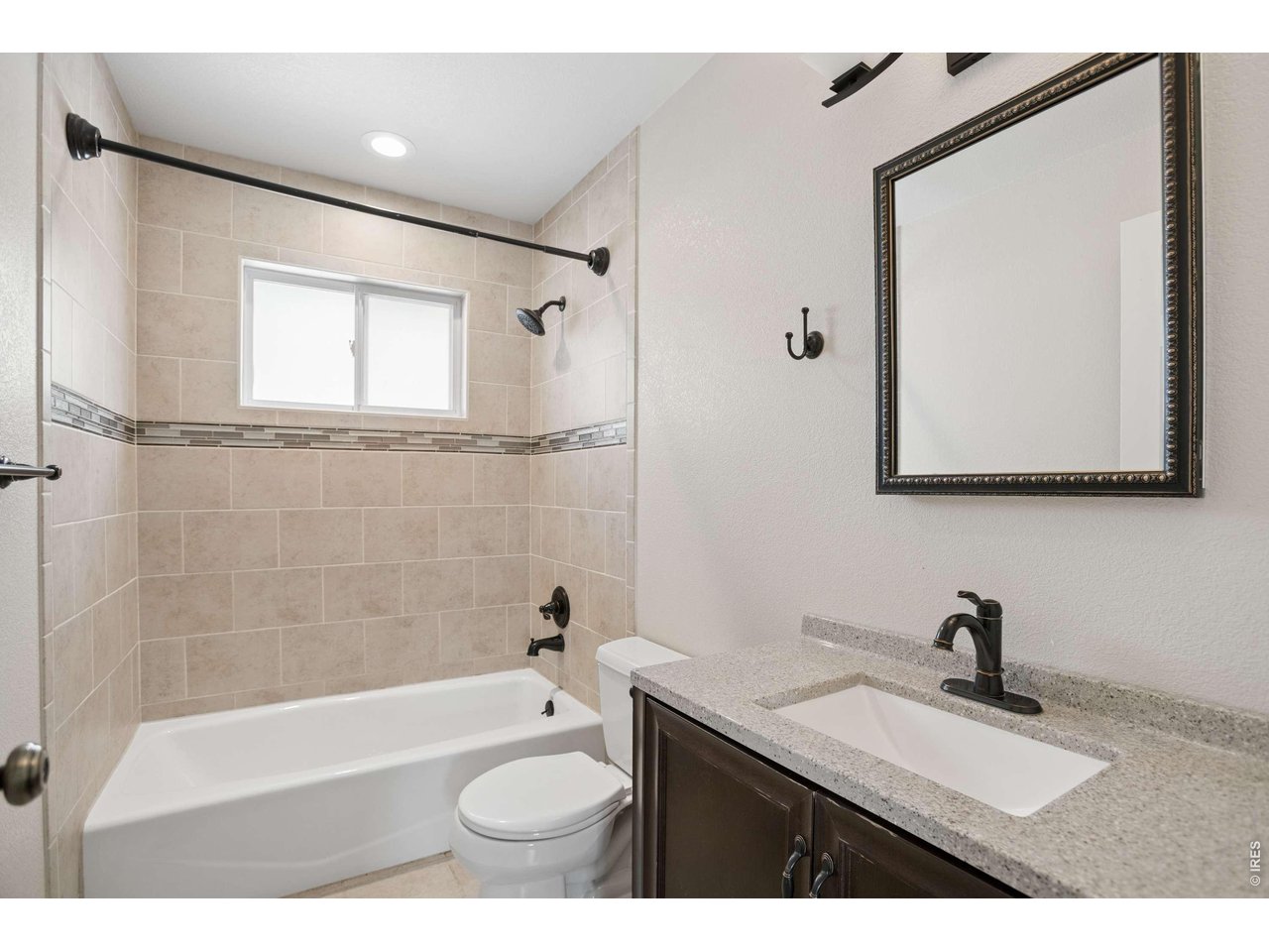 158 4th Street Firestone, CO 80520 - Photo 12 of 32 a bathroom with a granite countertop sink mirror toilet and bathtub