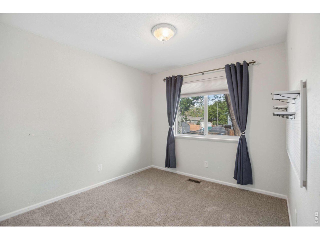 158 4th Street Firestone, CO 80520 - Photo 13 of 32 a room with a window and refrigerator