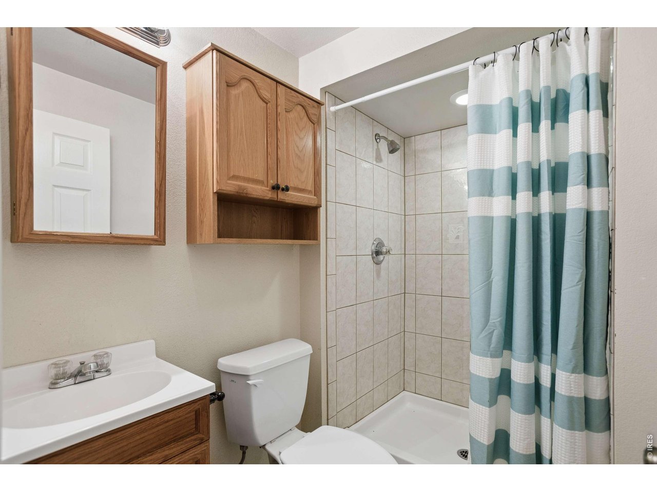 158 4th Street Firestone, CO 80520 - Photo 16 of 32 a bathroom with a sink toilet and shower