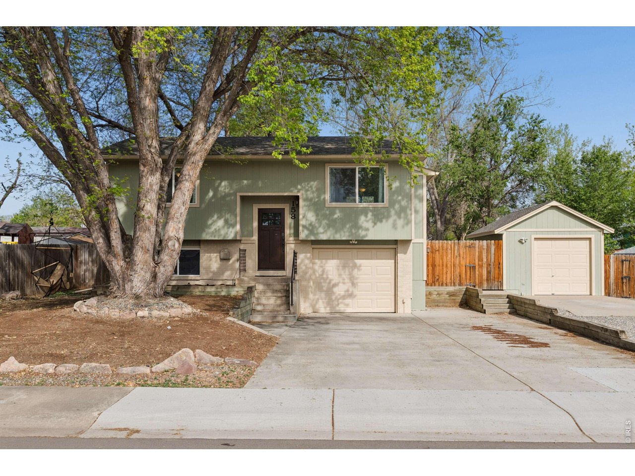 158 4th Street Firestone, CO 80520 - Photo 2 of 32 a front view of a house with a yard and garage