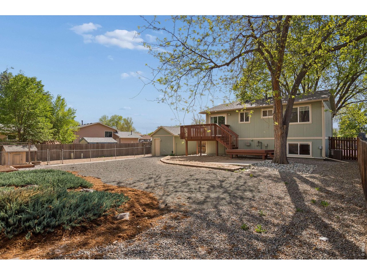 158 4th Street Firestone, CO 80520 - Photo 25 of 32 a backyard of a house with garden and garage