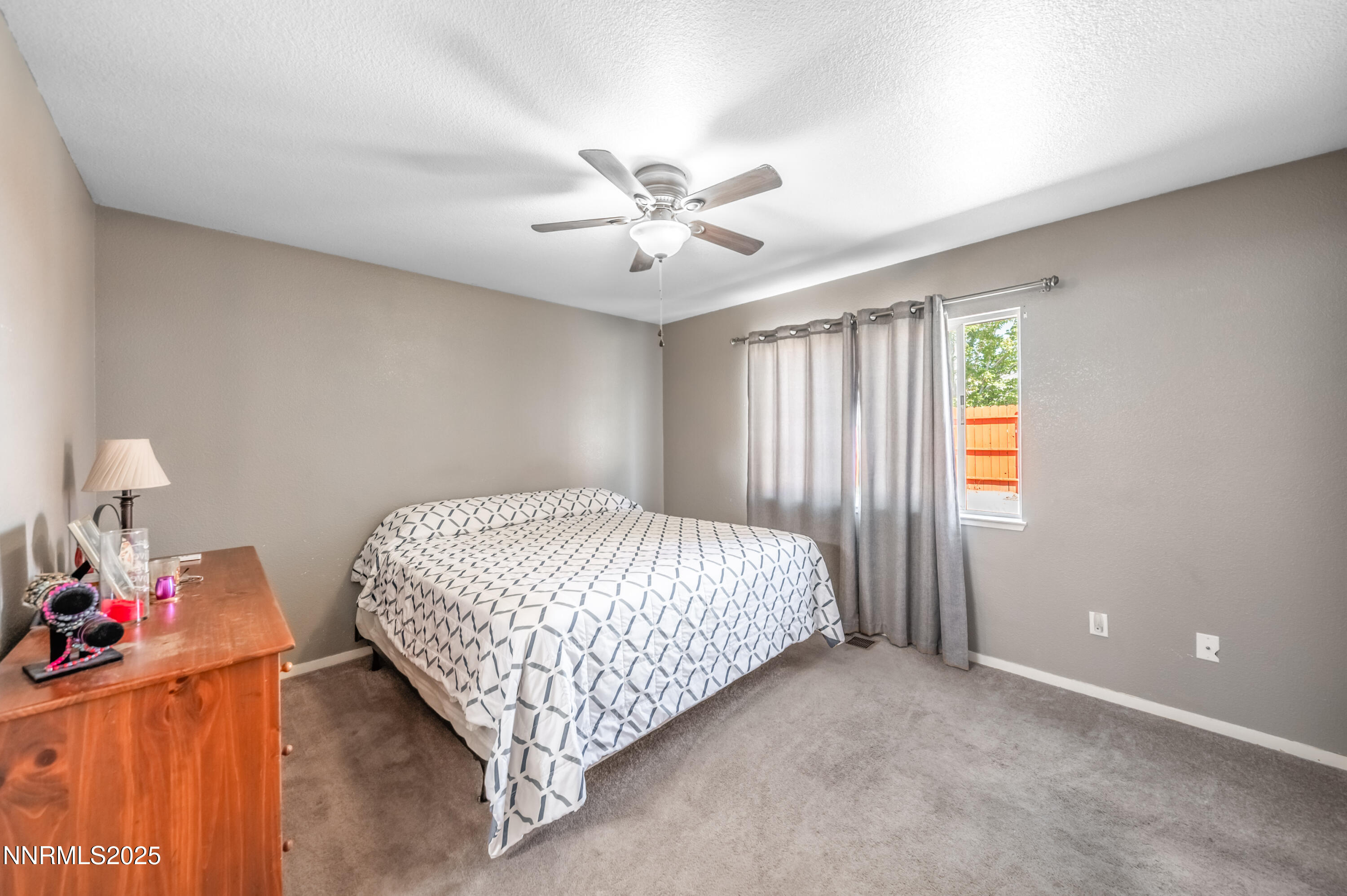 17523 Javalina Court Reno, NV 89508 - Photo 11 of 17 a bed sitting in a bedroom next to a window