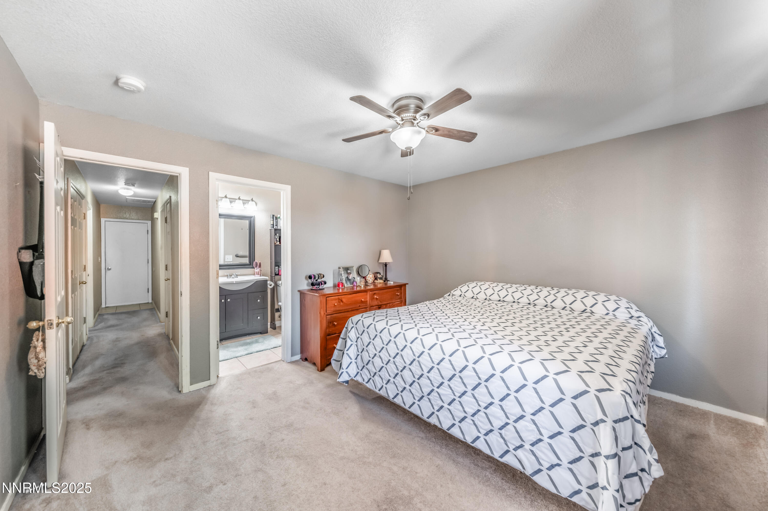 17523 Javalina Court Reno, NV 89508 - Photo 12 of 17 a bedroom with a bed and a chandelier