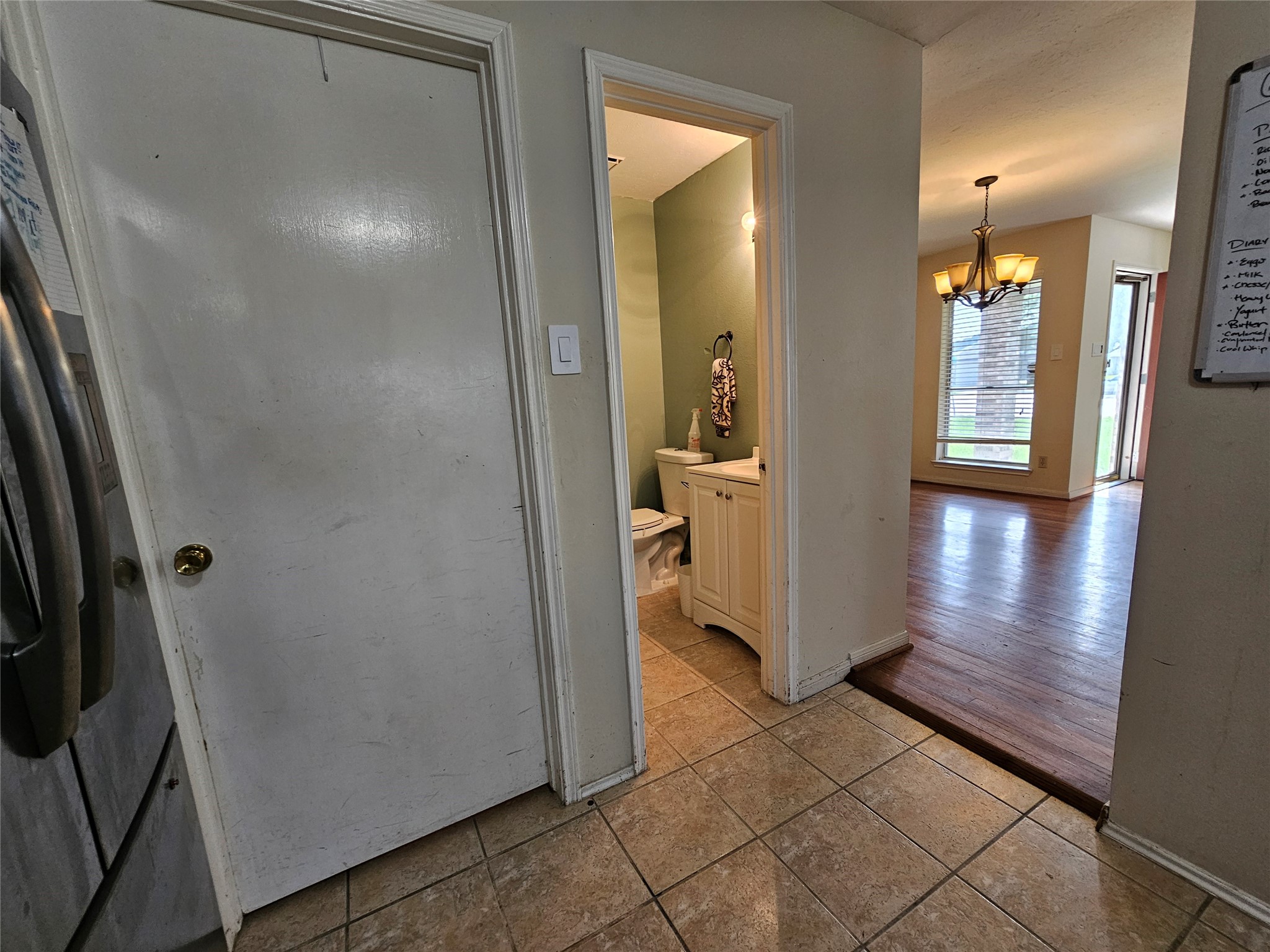 13615 Repa Lane Houston, TX 77014 - Photo 13 of 30 a view of a hallway with wooden floor and a bathroom