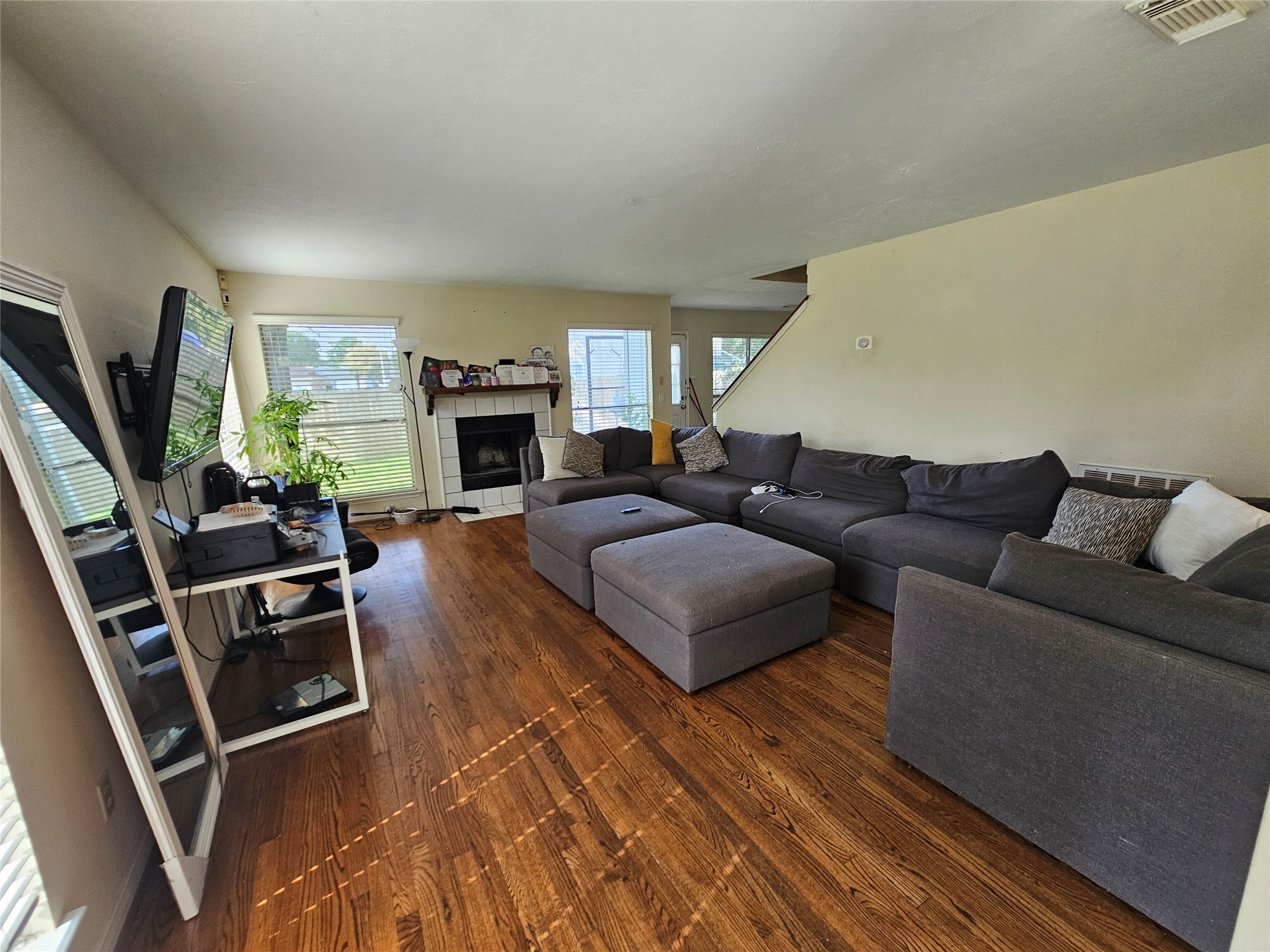 13615 Repa Lane Houston, TX 77014 - Photo 7 of 30 a living room with furniture a fireplace and a flat screen tv