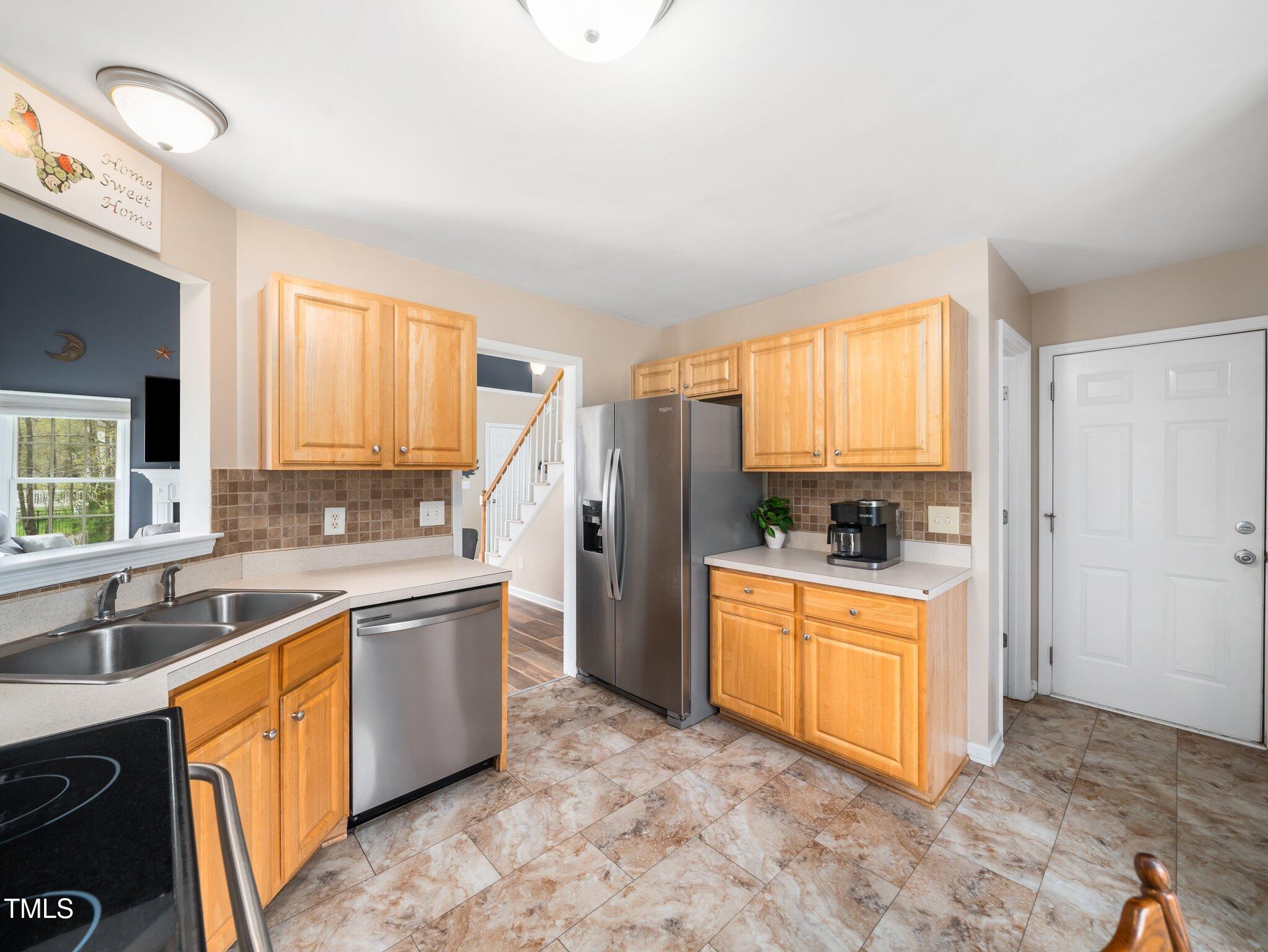 3690 Mabel Lane Stem, NC 27581 - Photo 11 of 37 a kitchen with stainless steel appliances granite countertop a stove a sink and a refrigerator