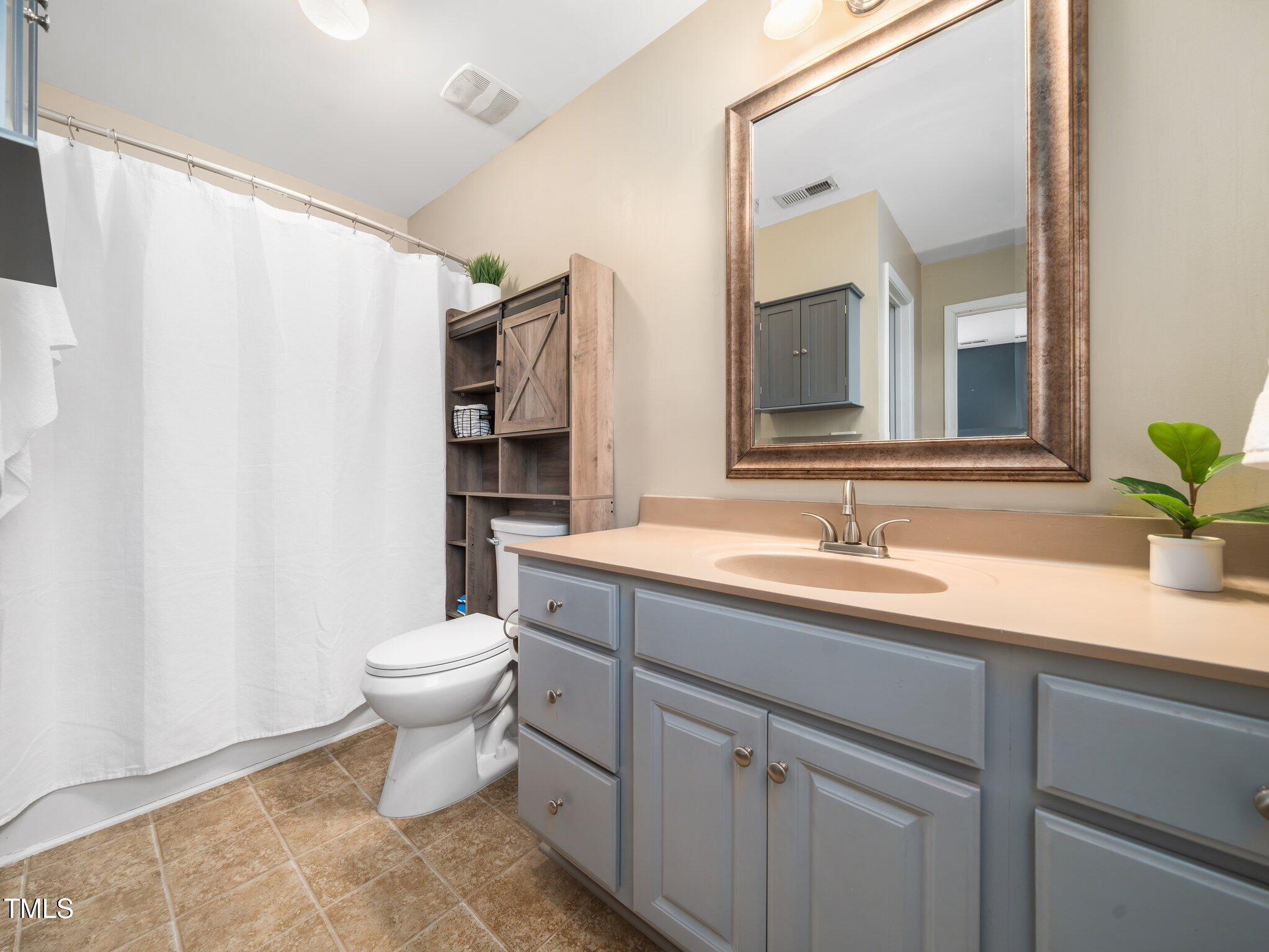 3690 Mabel Lane Stem, NC 27581 - Photo 18 of 37 a bathroom with a toilet sink and mirror