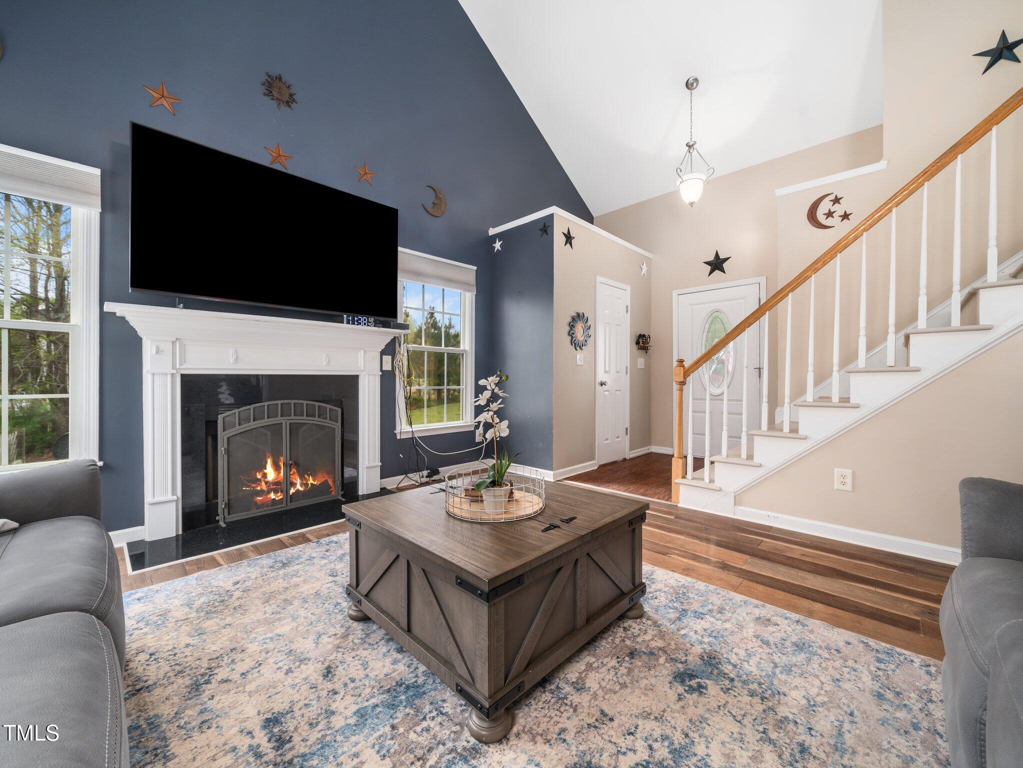 3690 Mabel Lane Stem, NC 27581 - Photo 4 of 37 a living room with furniture a flat screen tv and a fireplace
