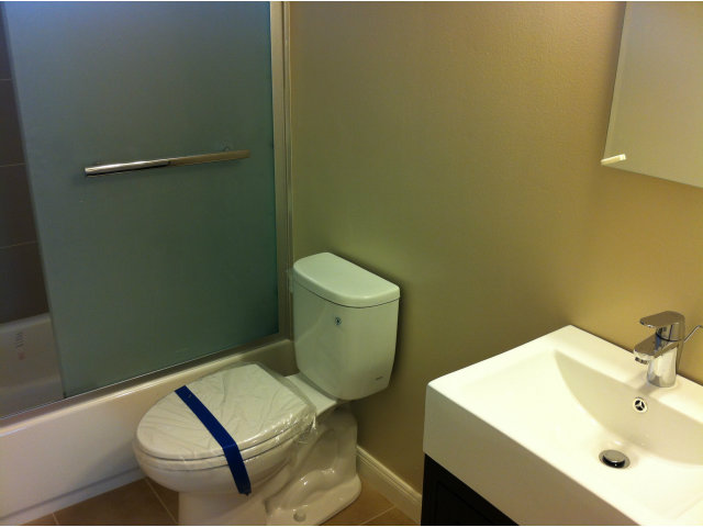 1231 Terra Nova Boulevard Pacifica, CA 94044 - Photo 14 of 18 a white toilet sitting next to a bathroom sink